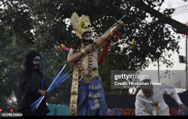 An artist plays the role of Ravana during the Dussehra festival celebration organised by Shri Dharmik Leela Committee at Lal Quila Grounds, on...