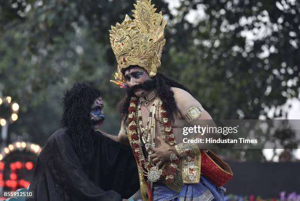 An artist plays the role of Ravana during the Dussehra festival celebration organised by Shri Dharmik Leela Committee at Lal Quila Grounds, on...