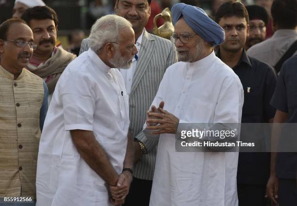 Prime Minister Narendra Modi talks to former PM Manmohan Singh during the Dussehra festival celebration organised by Shri Dharmik Leela Committee at...