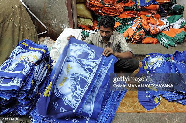 An Indian worker arranges Bahujan Samaj Party election campaign flags at a wholesale workshop in New Delhi on March 25, 2009. Election season means...