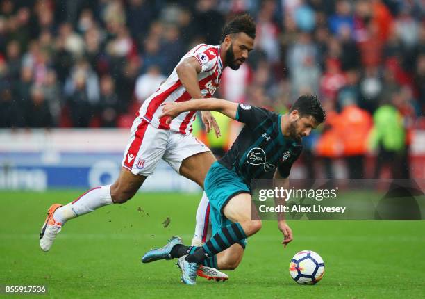 Maxim Choupo-Moting of Stoke City and Shane Long of Southampton battle for possession during the Premier League match between Stoke City and...