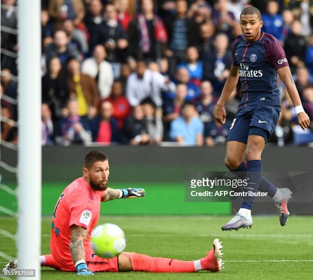 Paris Saint-Germain's French forward Kylian Mbappe scores his team's 6th goal past Bordeaux's French goalkeeper Benoit Costil during the French L1...