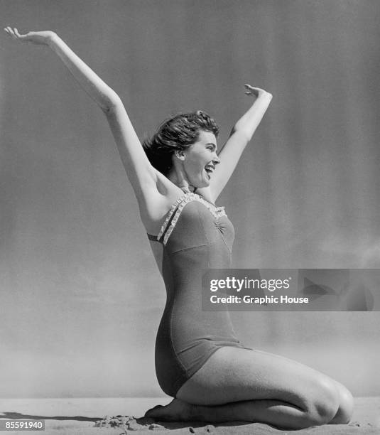 Brenda Parkinson, modelling a one-piece swimsuit, enjoys the sea air, circa 1955.