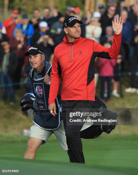 Robert Karlsson of Sweden waves to the crowd on the 18th green during the third round of the British Masters at Close House Golf Club on September...