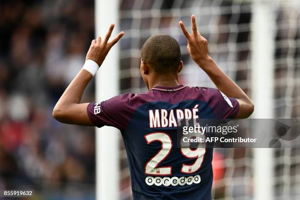 Paris Saint-Germain's French forward Kylian Mbappe reacts after scoring his team's 6th goal during the French L1 football match Paris Saint-Germain...