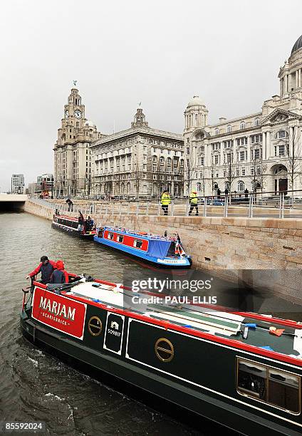 Canal boats enter a new waterway link in Liverpool, north west England on March 25, 2009. The new link, which is one and a half miles long, runs into...