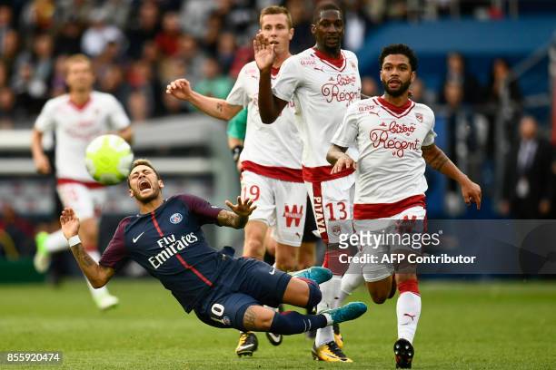 Paris Saint-Germain's Brazilian forward Neymar falls after being tackled as Bordeaux's Brazilian midfielder Otavio looks on during the French L1...