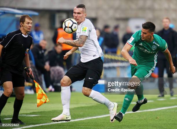 Anton Zabolotny of FC Tosno vies for the ball with Angel Romero of FC Akhmat during the during the Russian Premier League match between FC Tosno and...