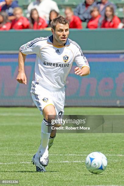 Dema Kovalenko of the Los Angeles Galaxy moves the ball up the field against the defense of D.C. United during the MLS game at Home Depot Center on...