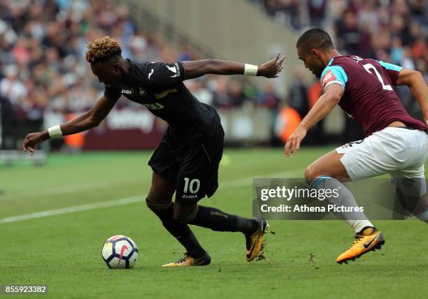 Tammy Abraham of Swansea City followed by Winston Reid of West Ham during the Premier League match between West Ham United v Swansea City at the...