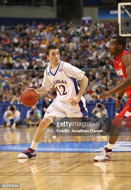 Brady Morningstar of the Kansas Jayhawks drives against the Dayton Flyers during the second round of the NCAA Division I Men's Basketball Tournament...
