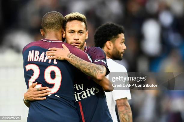 Paris Saint-Germain's Brazilian forward Neymar and Paris Saint-Germain's French forward Kylian Mbappe embrace after the French L1 football match...