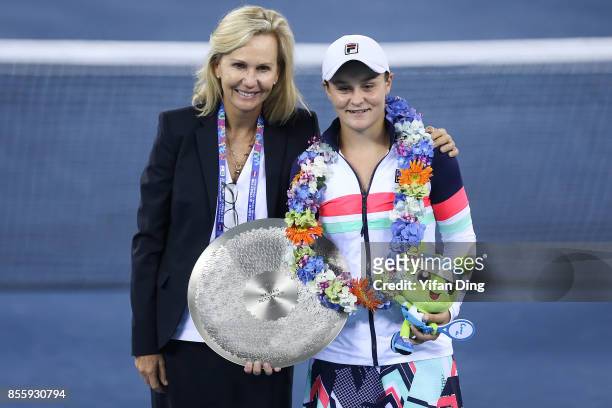 President Micky Lawler and Ashleigh Barty pose with the trophy at the award ceremony after the ladies singles final between Ashleigh Barty of...