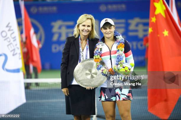 Ashleigh Barty with the trophy and Micky Lawler of WTA President pose at the award ceremony after the ladies singles final between Ashleigh Barty of...