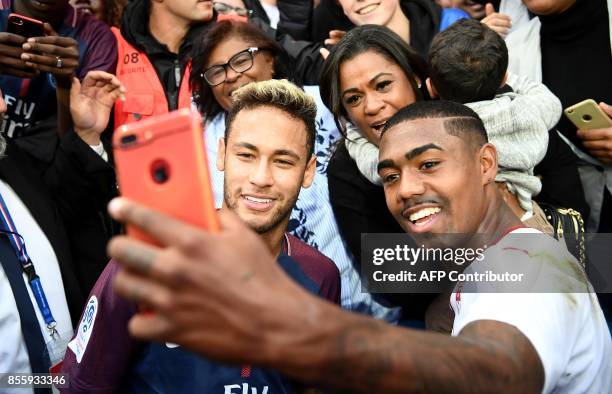 Paris Saint-Germain's Brazilian forward Neymar and Bordeaux's Brazilian forward Malcom take a selfie at the end of the French L1 football match...