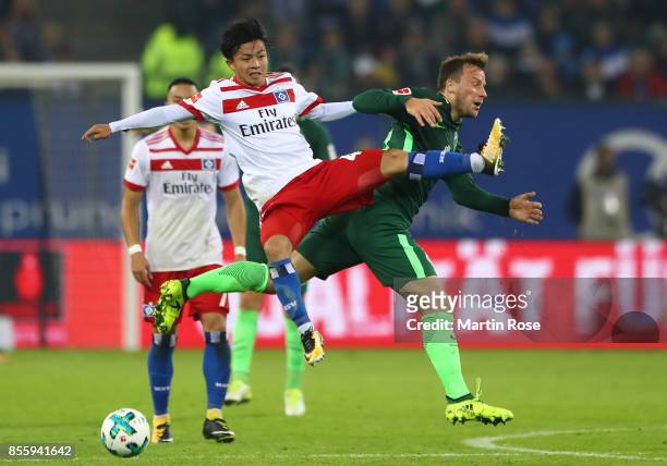 Tatsuya Ito of Hamburg fights for the ball with Philipp Bargfrede of Bremen during the Bundesliga match between Hamburger SV and SV Werder Bremen at...