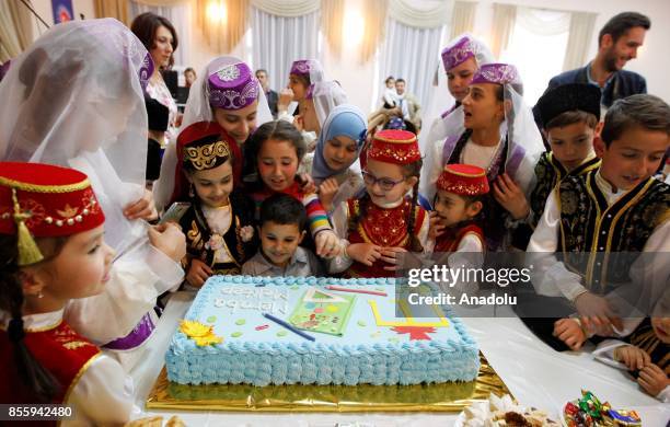 Hildren look at a cake during the opening ceremony of school number 165, which has been amended by TIKA in Kiev, Ukraine, on September 30, 2017.