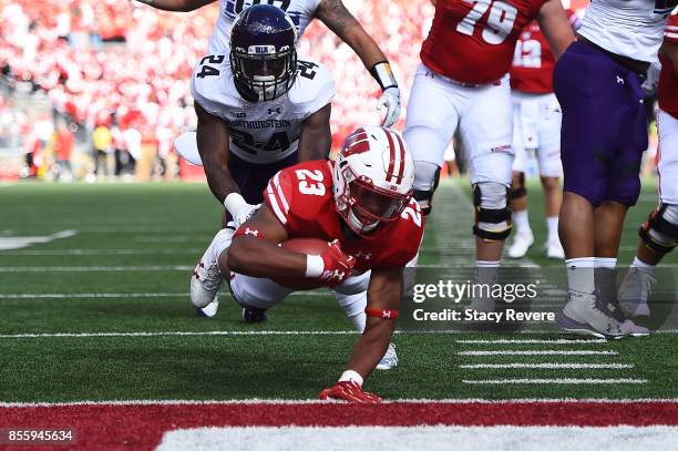 Jonathan Taylor of the Wisconsin Badgers dives for a touchdown during the first quarter of a game against the Northwestern Wildcats at Camp Randall...