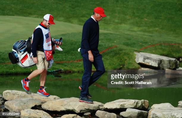Matt Kuchar of the U.S. Team and caddie John Wood walk to the 13th tee during the Saturday morning foursomes matches during the third round of the...