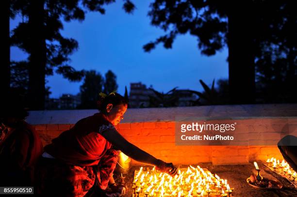 Nepalese Devotee offering butter lamps infornt Bramayani Temple during the tenth day of Dashain Durga Puja Festival in Bramayani Temple, Bhaktapur,...