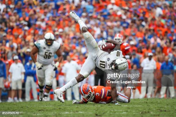 Trent Sherfield of the Vanderbilt Commodores makes a catch as Marco Wilson of the Florida Gators defends at Ben Hill Griffin Stadium on September 30,...