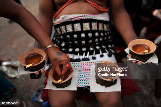 Family member arranging oil lamps as Nepalese devotee hold oil lamps on their body during the tenth day of Dashain Durga Puja Festival in Bramayani...