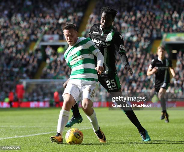 Callum McGregor of Celtic bids with Efe Ambrose of Hibernian during the Ladbrokes Scottish Premiership match between Celtic and Hibernian at Celtic...