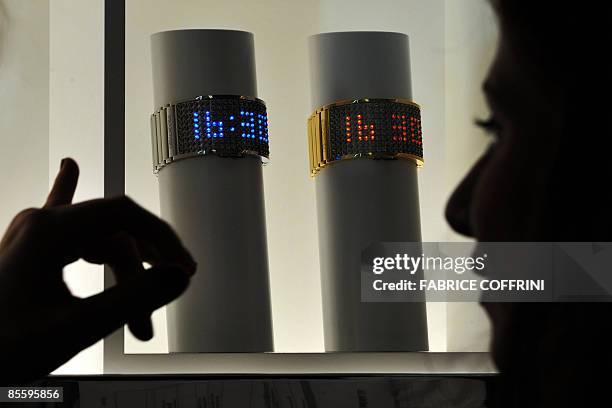 Woman points to Swarovski's 'D-light' model watches on display on the press day at the Baselworld 2009 watch and jewellery show on March 25, 2009 in...