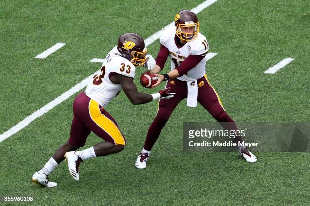 Shane Morris of the Central Michigan Chippewas hands the ball off to Kumehnnu Gwilly during the first quarter against the Boston College Eagles at...