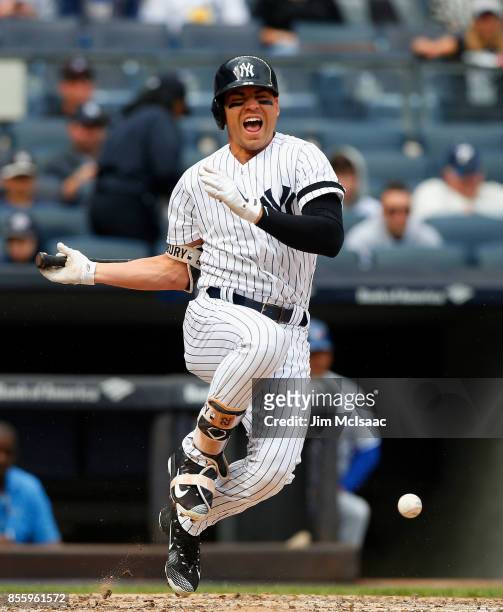 Jacoby Ellsbury of the New York Yankees reacts after fouling a ball off of his foot during the third inning against the Toronto Blue Jays at Yankee...