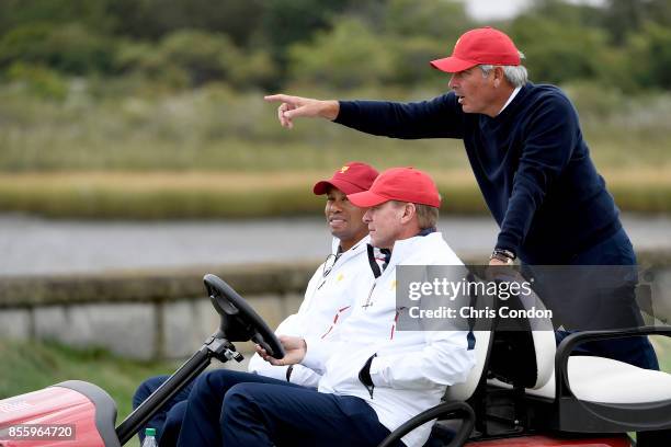Fred Couples, Captains Assistant, talks with Tiger Woods, Captains Assistant, and Steve Stricker, Captain of the U.S. Team, during the Saturday...