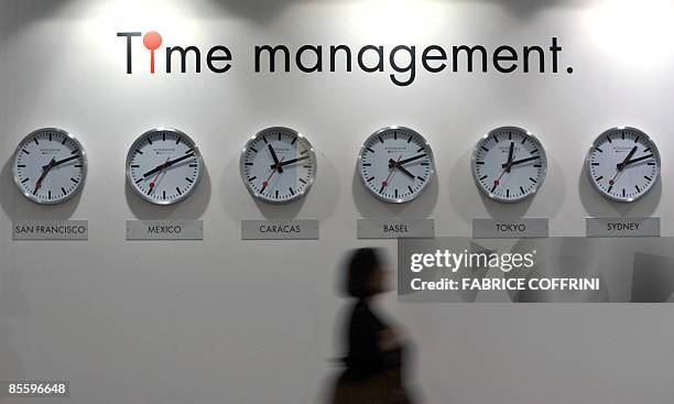 Visitor passes in front of watches at the Mondaine booth during the press day at the Baselworld 2009 watch and jewellery show on March 25, 2009 in...