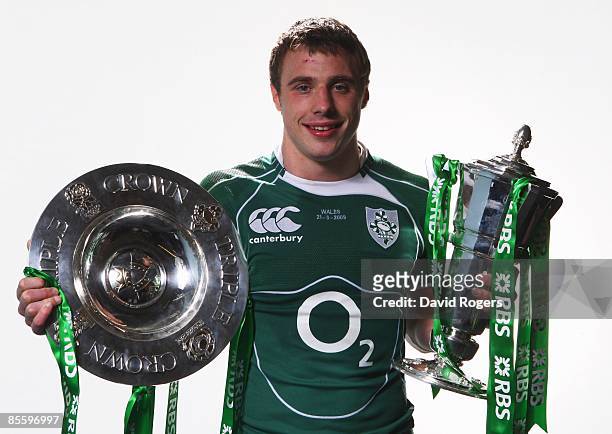 Tommy Bowe poses with the RBS Six Nations and Triple Crown trophies after the RBS Six Nations match between Wales and Ireland at the Millennium...