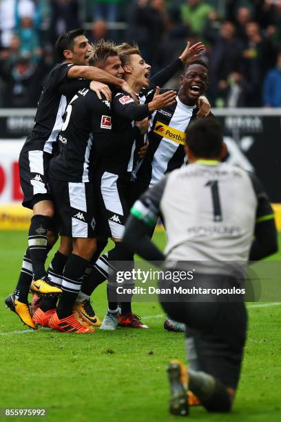 Thorgan Hazard of Moenchengladbach celebrates with his team after he scored the late winning goal form the penalty spot during the Bundesliga match...