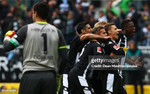 Thorgan Hazard of Moenchengladbach celebrates with his team after he scored the late winning goal form the penalty spot during the Bundesliga match...