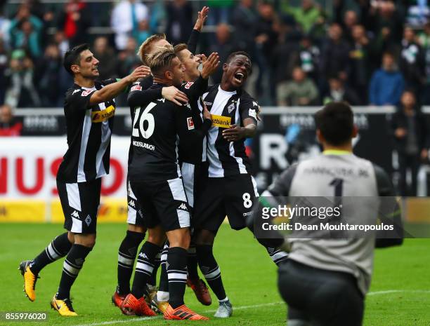 Thorgan Hazard of Moenchengladbach celebrates with his team after he scored the late winning goal form the penalty spot during the Bundesliga match...