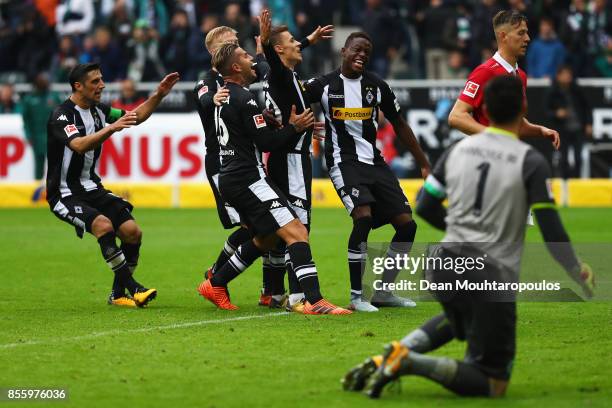 Thorgan Hazard of Moenchengladbach celebrates with his team after he scored the late winning goal form the penalty spot during the Bundesliga match...