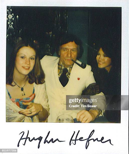 Autographed polaroid photograph of American businessman and Playboy founder Hugh Hefner as he poses with his daughter, Christie Hefner and...