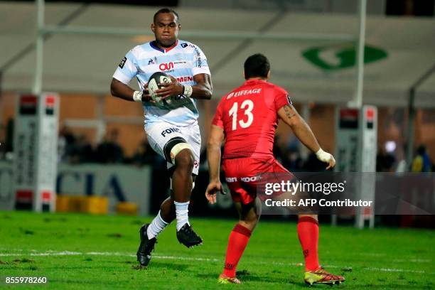 Racing-Metro's Leone Nakarawa runs with the ball during the French Top 14 rugby union match between Racing Metro 92 and Lyon Olympique Universitaire...