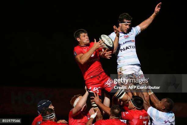 Lyon's French flanker Julien Puricelli and Racing-Metro's Manuel Carizza jump for the ball during the French Top 14 rugby union match between Racing...