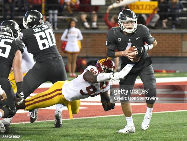 Washington State Cougars quarterback Luke Falk escapes the sack attempt of USC Trojans defensive tackle Rasheem Green during the game between the USC...
