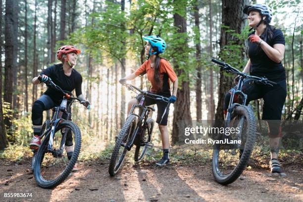 women mountain biking team - mountainbike stock pictures, royalty-free photos & images