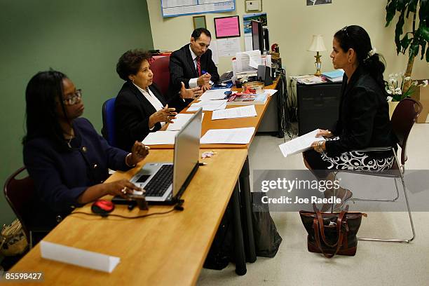 Muriel Odige sits across the table from Teresa Grant, Maritza Cedeno and Juan Hernandez as they interview her for one of fifty positions open with...