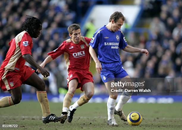 Chelsea's Arjen Robben is closed down by Portsmouth's Linvoy Primus and Gary O'Neil