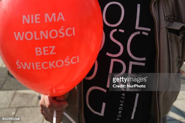 An activist holds a balloon with a description 'There is no freedom without secularity' during 'The March of Secularity' protest to demand a secular...