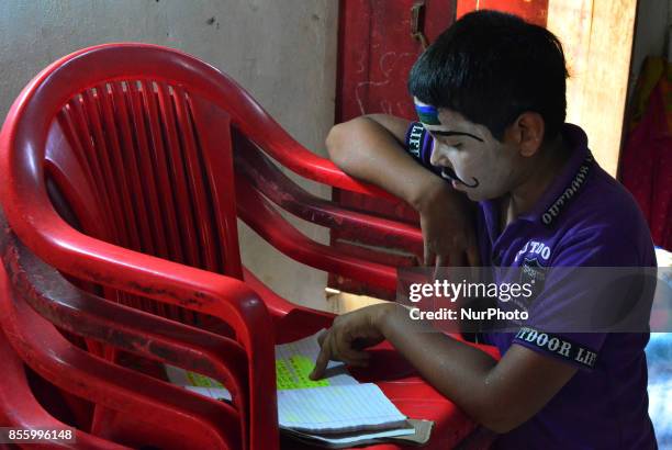 An Indian artist,dressed as a character prepares for his dialogues, brfore traditional Ramleela,a play narrating the life of Hindu God Ram,on...