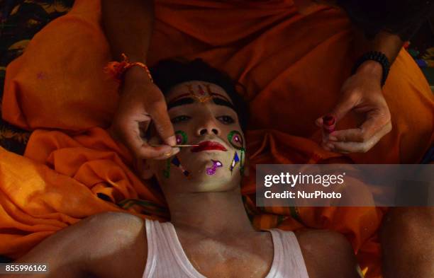 An Indian man applies make up on an artist before traditional Ramleela,a play narrating the life of Hindu God Ram,on ocassion of Dussehra festival,in...