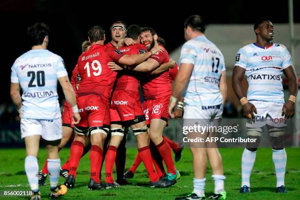 Lyon's players celebrate their victory at the end of the French Top 14 rugby union match between Racing Metro 92 and Lyon Olympique Universitaire on...