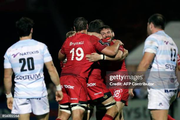 Lyon's players celebrate their victory at the end of the French Top 14 rugby union match between Racing Metro 92 and Lyon Olympique Universitaire on...