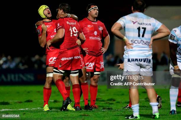 Lyon's players celebrate their victory at the end of the French Top 14 rugby union match between Racing Metro 92 and Lyon Olympique Universitaire on...